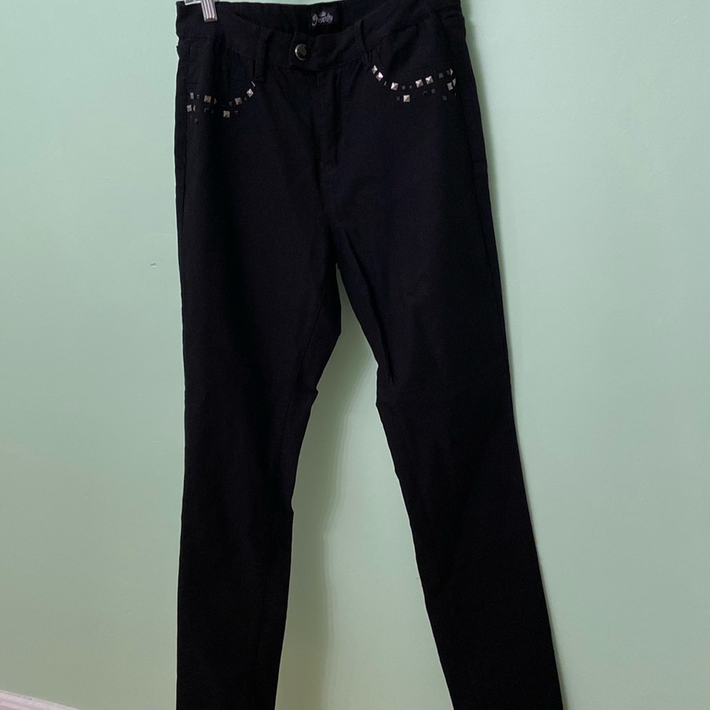Black jean pants with rhinestones designs around the front and back pockets